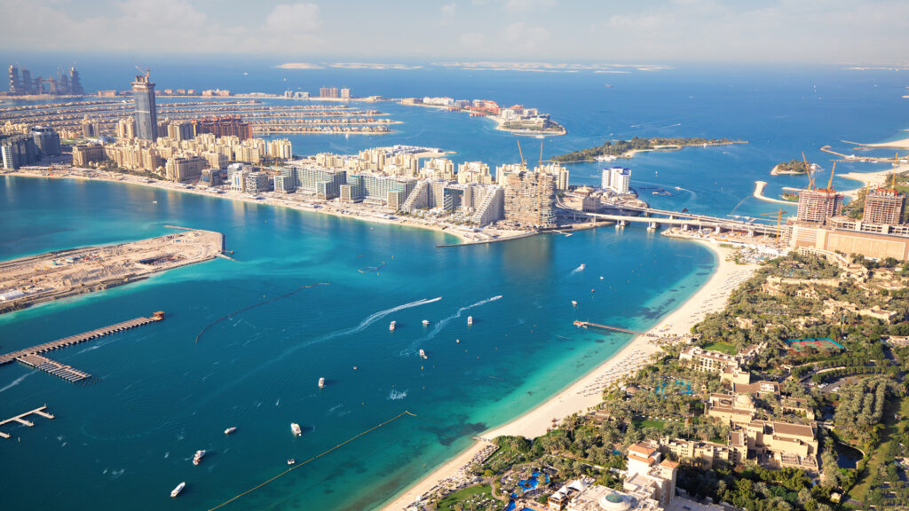 Aerial view from Dubai coast with beaches and blue water on Jumeirah island and Marina