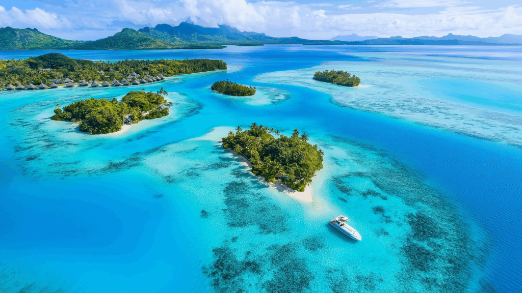 Aerial view of a tropical lagoon with turquoise water and small islands in Bora Bora, French Polynesia.